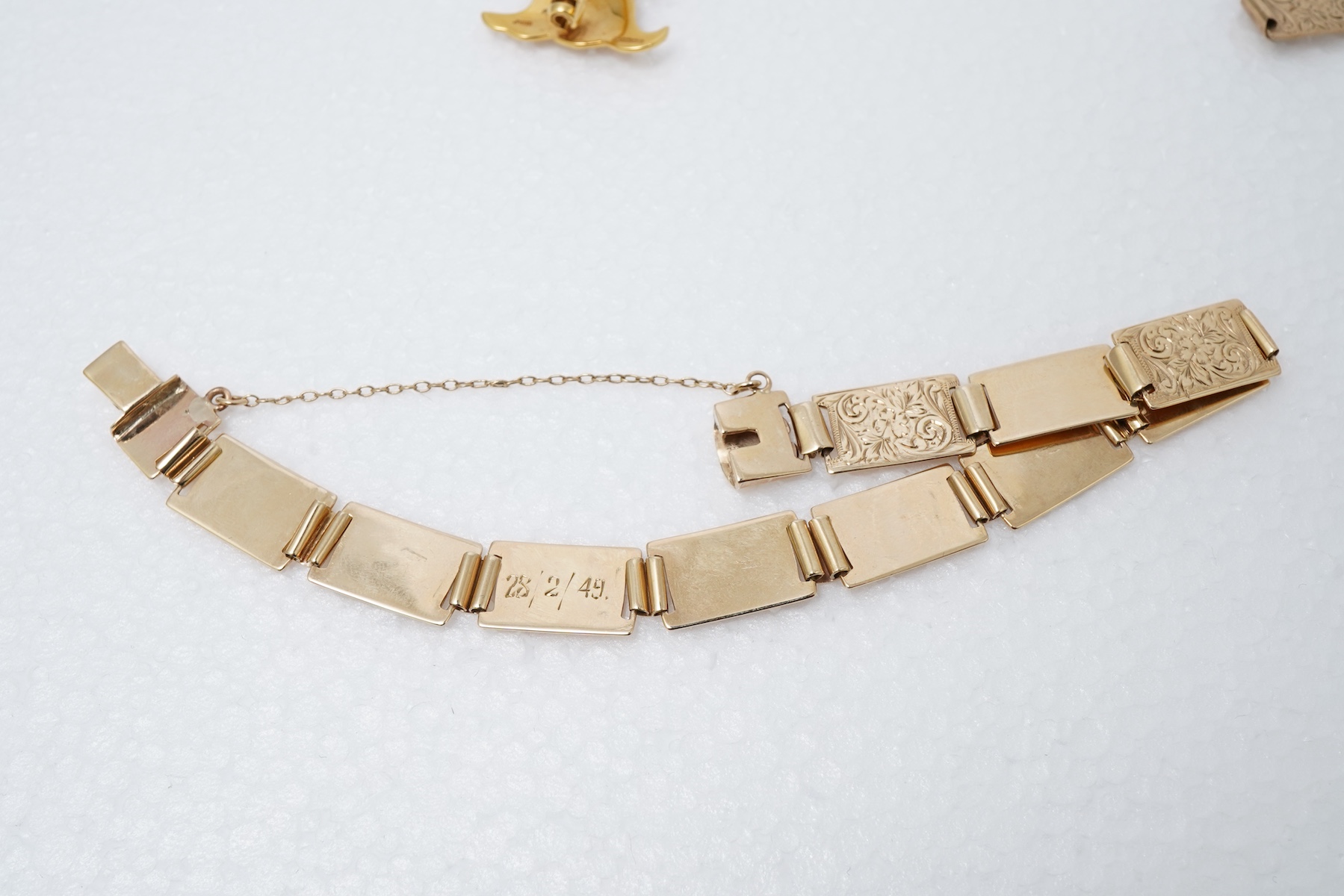 An 18ct gold livery brooch and a gold panel bracelet